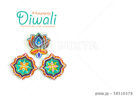 Happy Diwali - Clay Diya lamps lit during Dipavali, Hindu festival of lights celebration. Colorful traditional oil lamp diya on white background. Copy space for text. 58510379