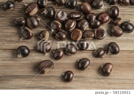 ripe and fresh chestnuts on a wooden table 58510931