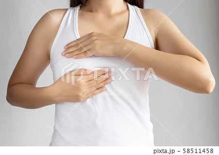 woman in white vest use her hand for breast cancer self check. healthy woman lifestyle medical awareness concept woman in white vest use her hand for breast cancer self check. healthy woman lifestyle medical awareness concept 58511458