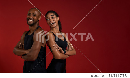 Staying healthy. Young and positive african fitness couple in sportswear looking at camera with Staying healthy. Young and positive african fitness couple in sportswear looking at camera with 58511758