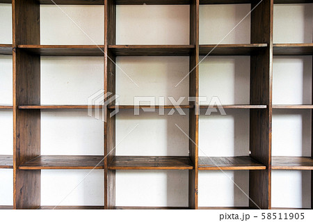 empty wooden cupboard storage near white wall, modern interior closeup 58511905
