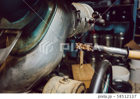 Sample being taken out of coffee roaster 58512137