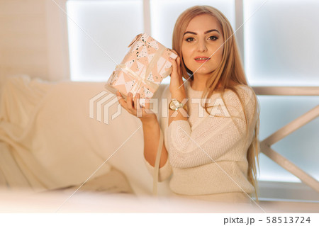 Elegant woman in white dress in winter holiday. Christmas mood Elegant woman in white dress in winter holiday. Christmas mood 58513724