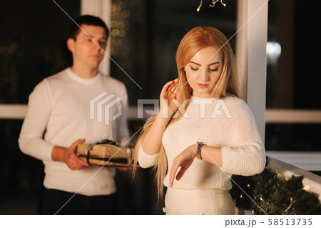 Husband gives present for his wife, background of window. Happy woman take present Husband gives present for his wife, background of window. Happy woman take present 58513735