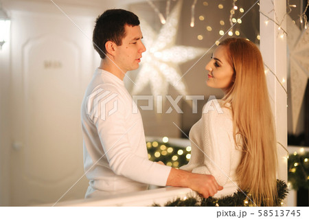Man and woman in white at Christmas time. Happy family Man and woman in white at Christmas time. Happy family 58513745