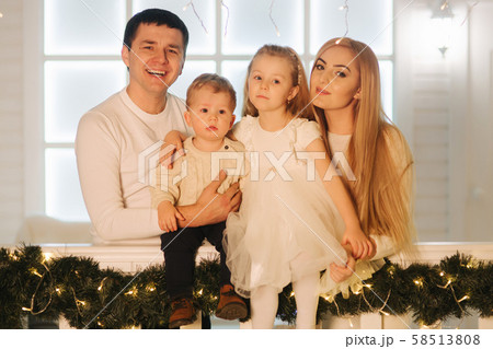 Happy family spend time together on Christmas.Portrait of Mom dad, Daughter and son on winter Happy family spend time together on Christmas.Portrait of Mom dad, Daughter and son on winter 58513808