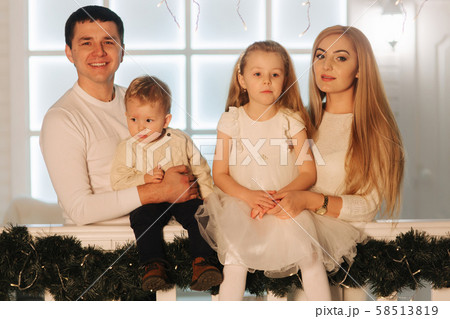 Happy family spend time together on Christmas.Portrait of Mom dad, Daughter and son on winter Happy family spend time together on Christmas.Portrait of Mom dad, Daughter and son on winter 58513819