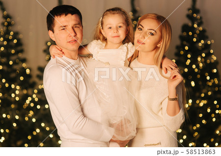 Little girl on holliday with mom and dad. Happy family on Christmas 58513863