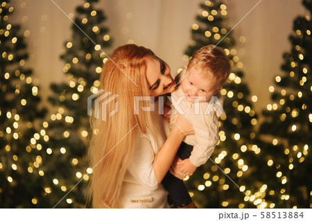 Mom play with her cute little son on holiday. Chrisrmas mood Mom play with her cute little son on holiday. Chrisrmas mood 58513884