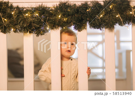 Little boy sitting on bench outside in Christmas time. Happy child 58513940