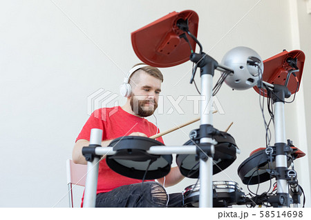 People, music and hobby concept - young man playing the drum People, music and hobby concept - young man playing the drum 58514698