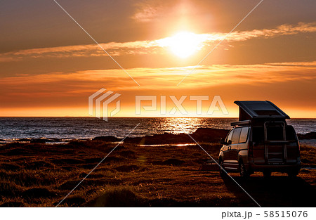 Camping car minivan on the beach at sunset Lofoten 58515076