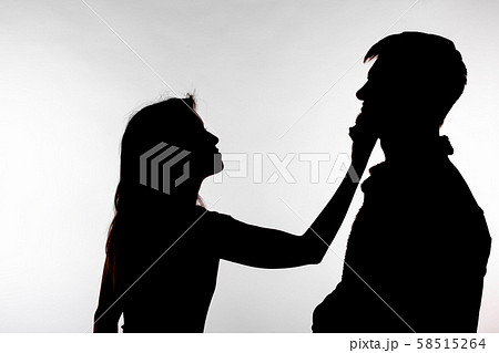 Aggression and abuse concept - man and woman expressing domestic violence in studio silhouette 58515264