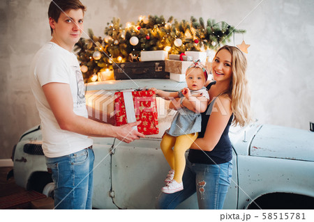 Lovely daddy giving Christmas present, big red box 58515781