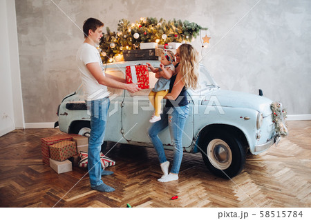 Lovely daddy giving Christmas present, big red box 58515784