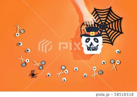 Happy halloween with candies and bucket on orange 58516318