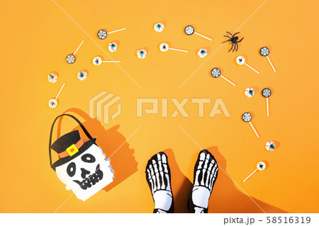 Happy halloween with candies and bucket on orange 58516319