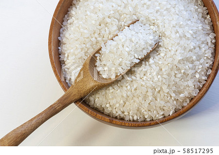 Uncooked dry rice in wooden bowl isolated on white 58517295