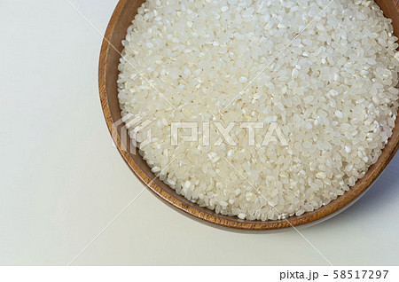 Uncooked dry rice in wooden bowl isolated on white 58517297