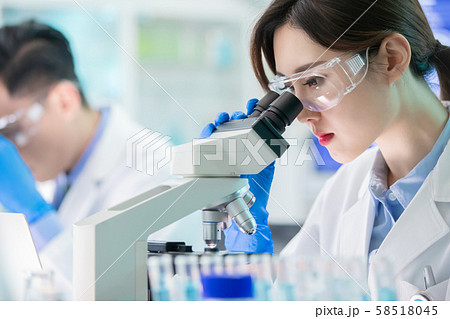 Asian scientist use microscope Asian scientist use microscope 58518045