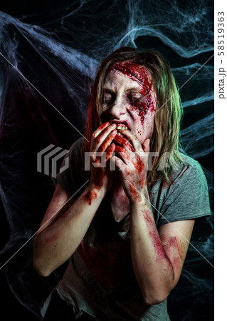 portrait of horrible zombie woman with wounds. Horror. Halloween make-up and costume portrait of horrible zombie woman with wounds. Horror. Halloween make-up and costume 58519363