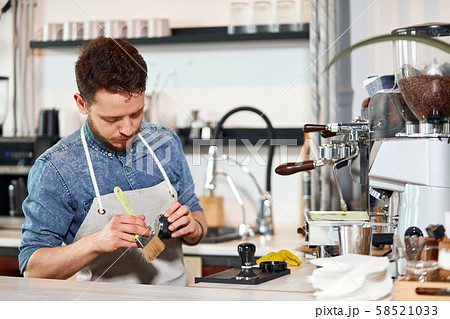 Young bearded man standing at bar counter 58521033