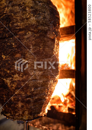 Close up shot of stacked meat roasting to be used in preparation of traditional Greek dish gyros or 58523800