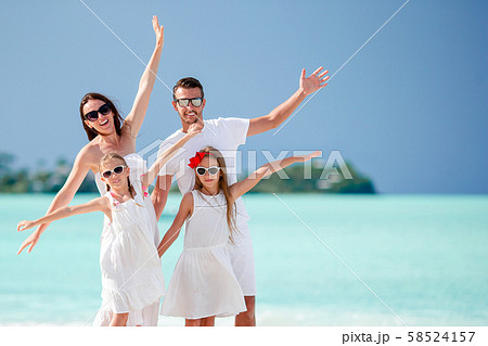 Happy beautiful family of four on the beach 58524157