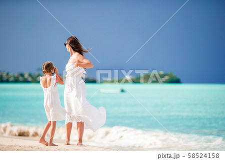 Beautiful mother and daughter on Caribbean beach Beautiful mother and daughter on Caribbean beach 58524158