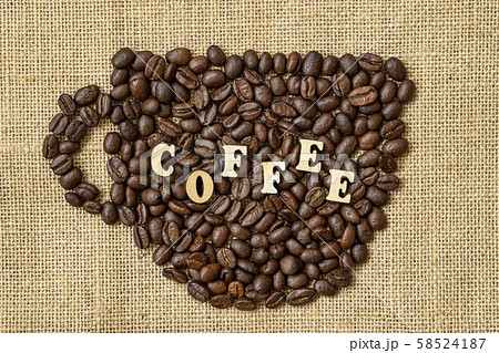 Roasted coffee beans in the shape of cup with word coffee on natural canvas, sackcloth . Concept of Roasted coffee beans in the shape of cup with word coffee on natural canvas, sackcloth . Concept of 58524187