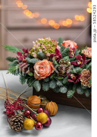 Beautiful festive arrangement of fresh spruce with ball toys in a rustic wooden box. Christmas mood Beautiful festive arrangement of fresh spruce with ball toys in a rustic wooden box. Christmas mood 58524293