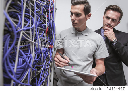 Engeneers in network server room 58524467