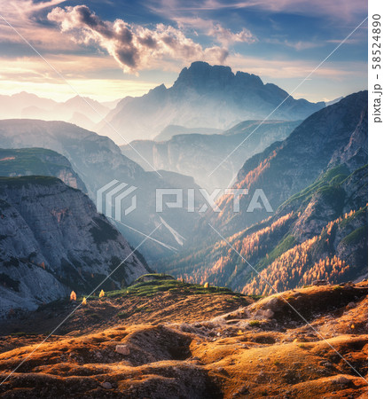 Mountain canyon lighted by bright sunbeams at sunset in autumn in Dolomites, Italy 58524890