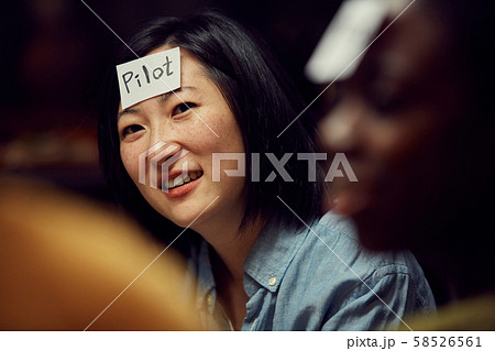 Asian Woman Playing Guessing Game 58526561