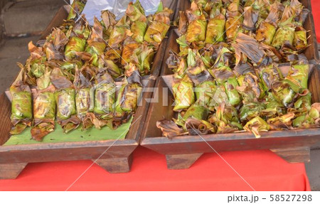 Thailand desserts wrapped in banana leaves. 58527298