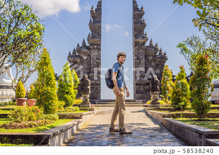 Young man tourist in budhist temple Brahma Vihara Arama Banjar Bali, Indonesia 58538240