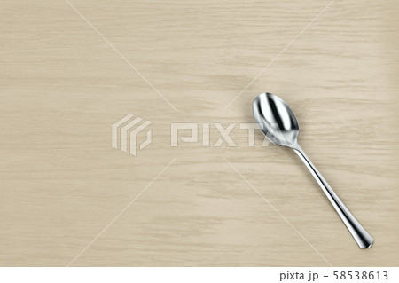 Silver spoon on table 58538613