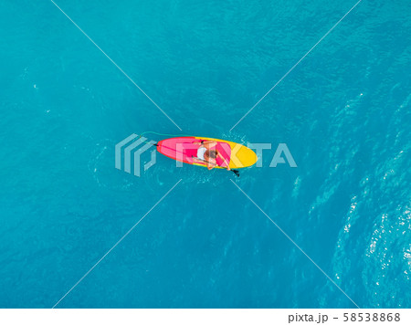Attractive woman on stand up paddle board on a quiet blue ocean. Sup surfing in tropical sea 58538868