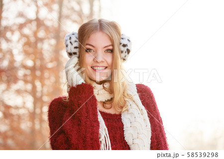 Portrait of pretty smiling woman in earmuffs. Portrait of pretty smiling woman in earmuffs. 58539298