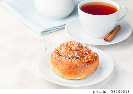 One cinnamon bun on a white plate One cinnamon bun on a white plate 58539613