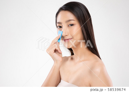 Beautiful Attractive Asian woman using Facial oil clean film to removal oily on face for face fresh skin feeling so fresh and clean,Beauty Concept,Isolated on grey background 58539674