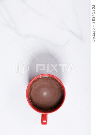 Red ceramic cups of hot cocoa on top of white 58541502