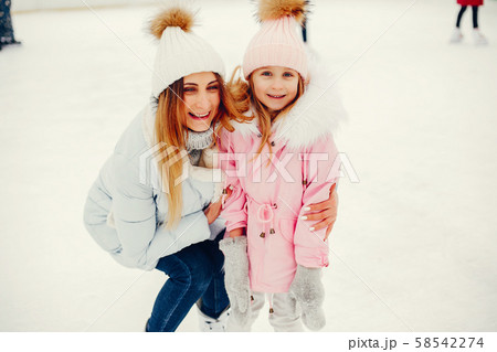 Cute and beautiful family in a winter city Cute and beautiful family in a winter city 58542274