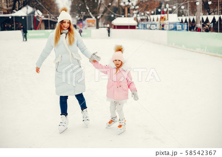 Cute and beautiful family in a winter city Cute and beautiful family in a winter city 58542367