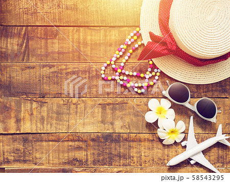 flat lay of hat , necklace , sun glass , flower and red heart shape as traveler's accessories items for summer vacation and plane model on wooden background with copy space. love travel and vacation flat lay of hat , necklace , sun glass , flower and red heart shape as traveler's accessories items for summer vacation and plane model on wooden background with copy space. love travel and vacation 58543295
