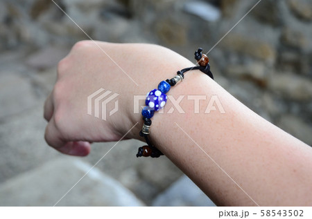 Wrist with a string of beads 58543502