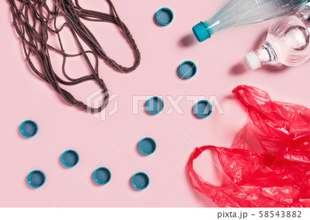 Zero waste concept. Mesh textile bag with plastic bottles, cups and package. Zero waste concept. Mesh textile bag with plastic bottles, cups and package. 58543882