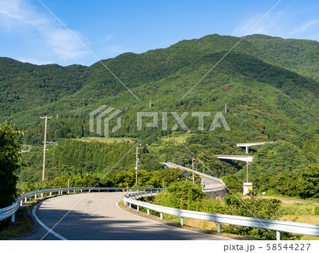 快晴の南会津の山に続く九十九折の道 58544227