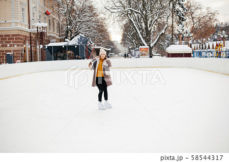 Cute and beautiful girl in a winter city Cute and beautiful girl in a winter city 58544317
