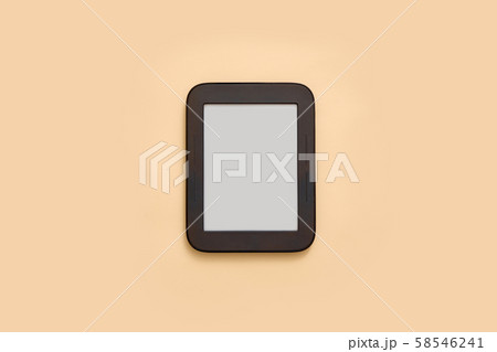 Ebook mockup with empty screen on beige background. Top view flat lay. Student or school library 58546241